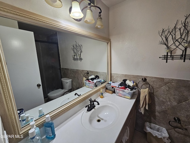 bathroom featuring walk in shower, vanity, and toilet