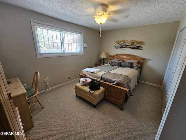 carpeted bedroom with ceiling fan, a textured ceiling, and a closet