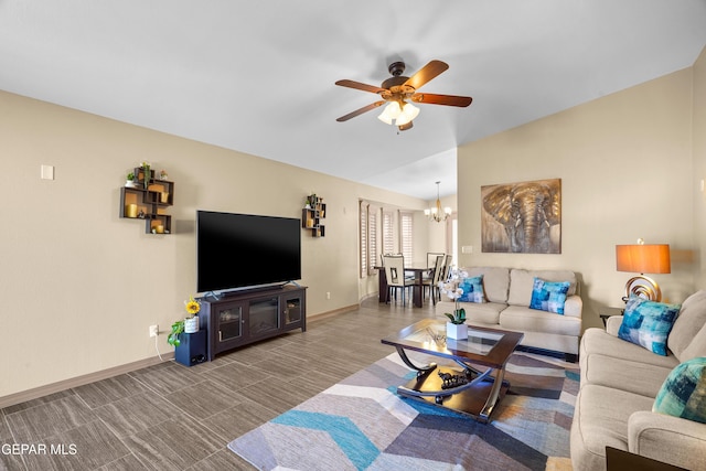 living room with ceiling fan with notable chandelier