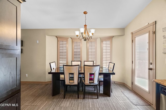 dining space featuring a healthy amount of sunlight and a notable chandelier