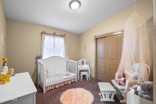 carpeted bedroom with vaulted ceiling and a crib