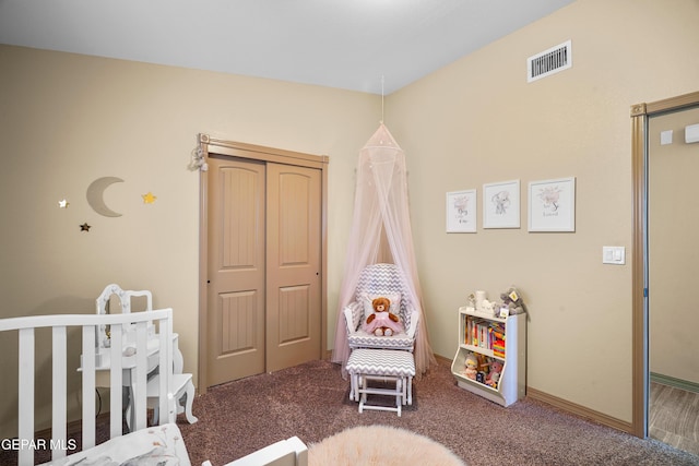 carpeted bedroom with a crib