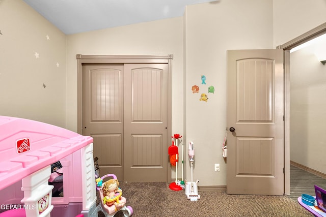 bedroom featuring carpet flooring, a closet, and vaulted ceiling