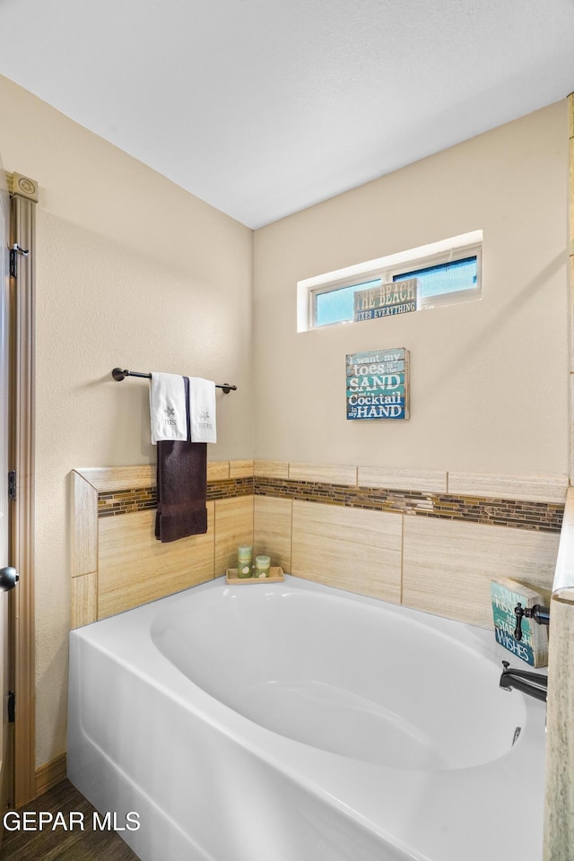 bathroom featuring a tub to relax in