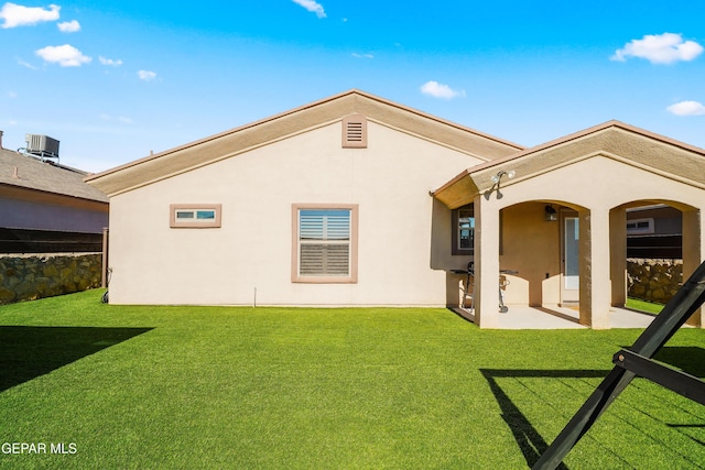 rear view of property with a lawn, central AC unit, and a patio