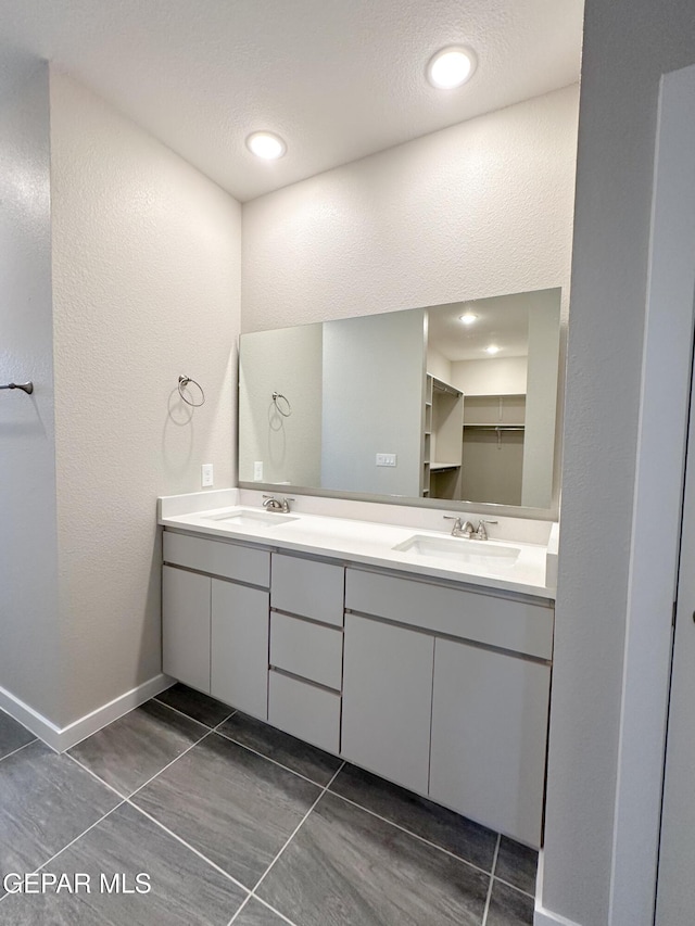 bathroom with tile patterned flooring and vanity