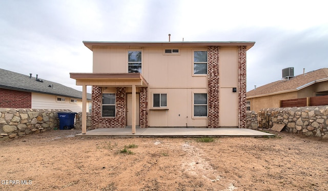 rear view of house with cooling unit and a patio area