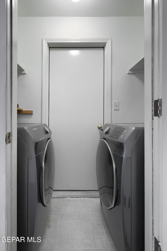 washroom featuring washing machine and clothes dryer