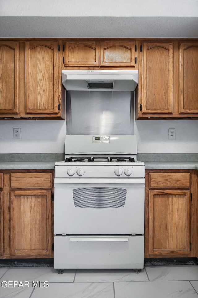 kitchen featuring white range with gas cooktop