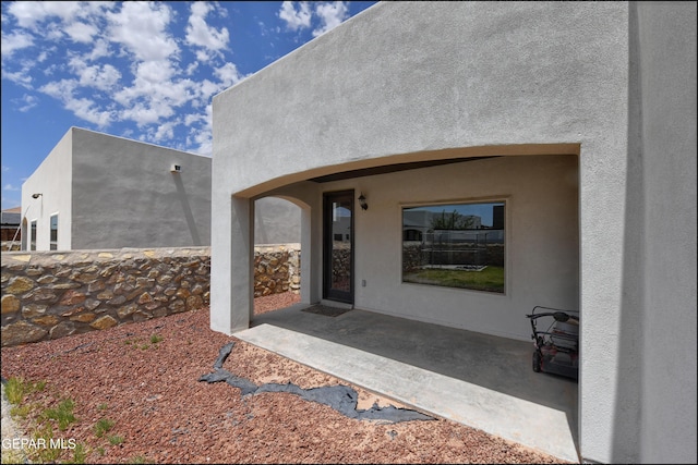 property entrance with a patio area