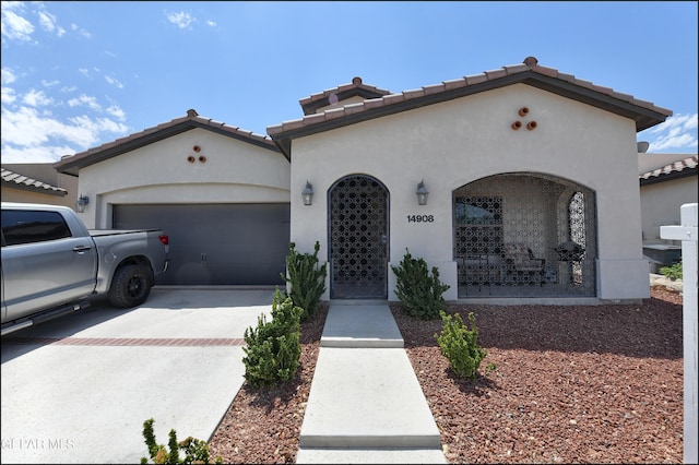 mediterranean / spanish-style home with a garage