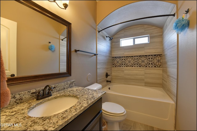 full bathroom with vanity, shower / bath combination, lofted ceiling, and toilet