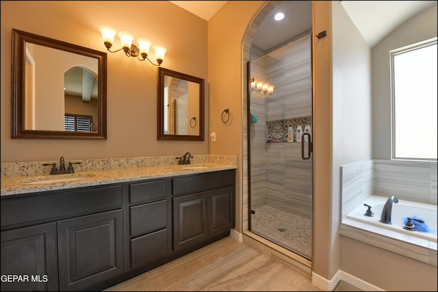 bathroom with shower with separate bathtub, vanity, plenty of natural light, and lofted ceiling