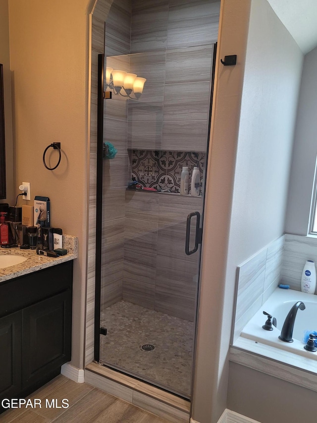 bathroom with vanity and separate shower and tub