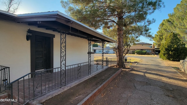 view of side of home with covered porch