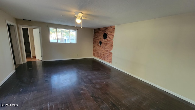 spare room with ceiling fan and dark hardwood / wood-style flooring