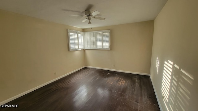 empty room with dark wood-type flooring and ceiling fan