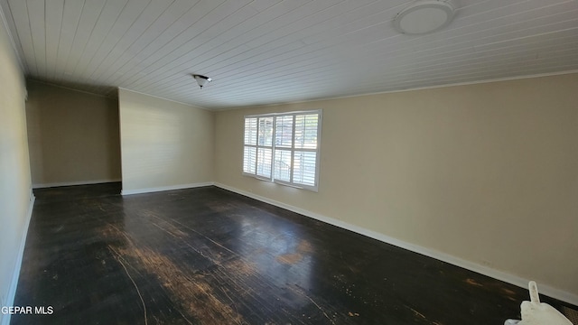 unfurnished room with dark wood-type flooring and wooden ceiling