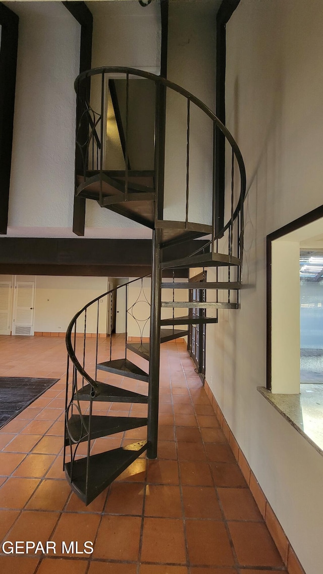 stairs featuring tile patterned flooring