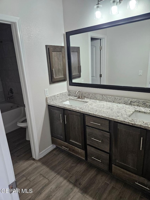 full bathroom featuring vanity, shower / bath combination, and toilet