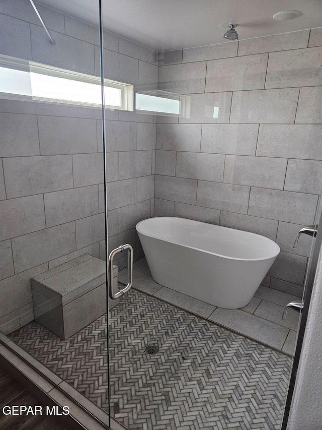 bathroom featuring separate shower and tub and tile patterned flooring