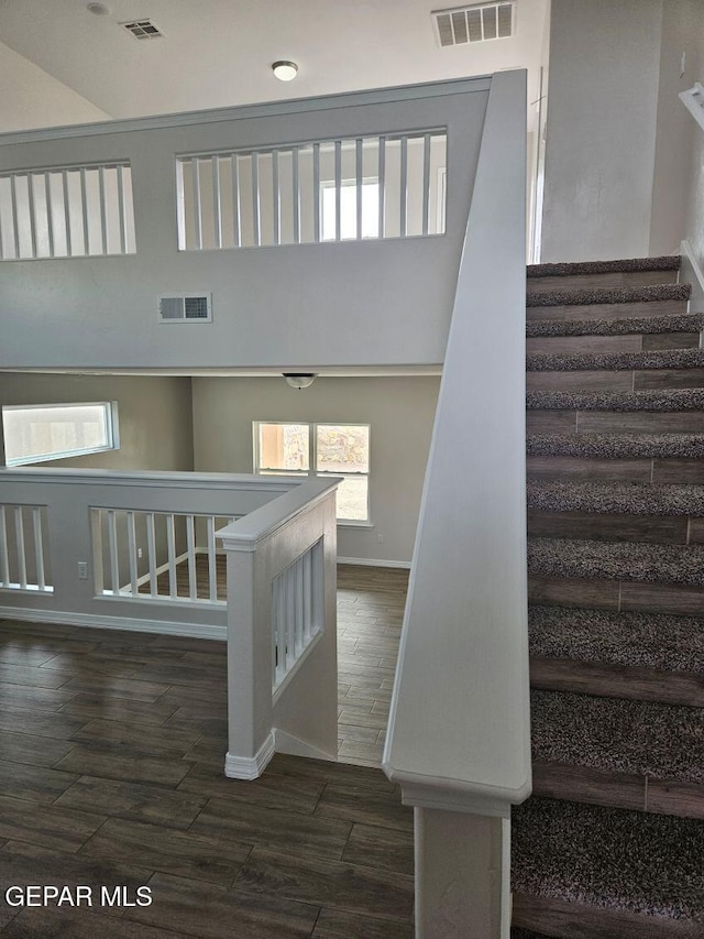 staircase with a towering ceiling