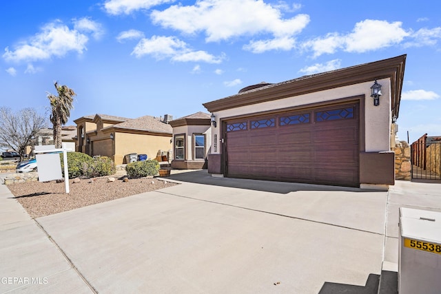 view of front of property with stucco siding and a garage