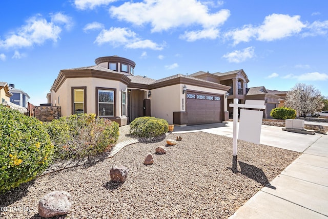 prairie-style home featuring stucco siding, a garage, and driveway