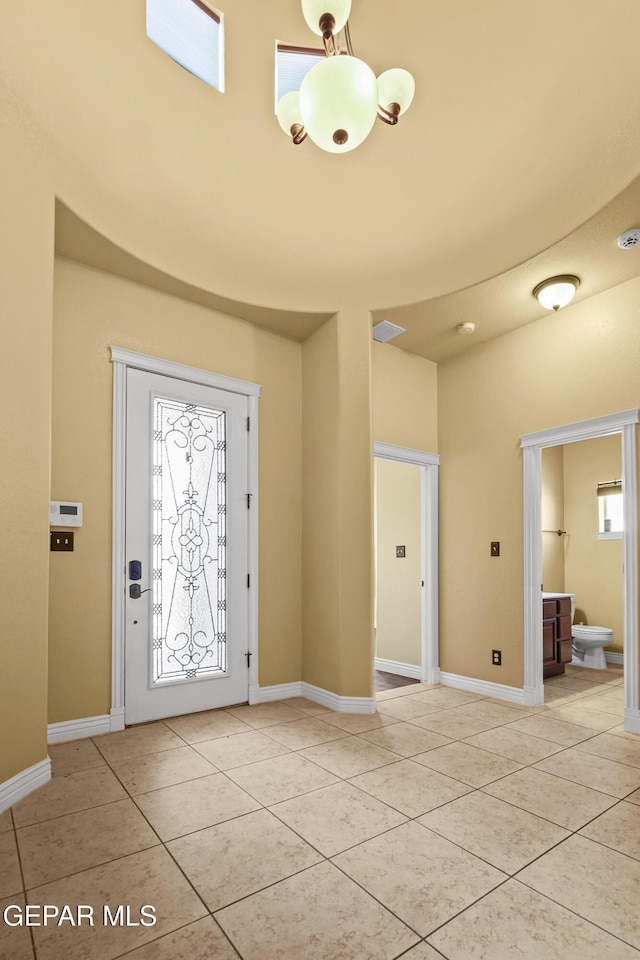 entrance foyer featuring light tile patterned floors and baseboards