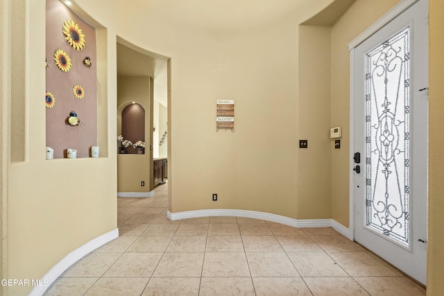 entrance foyer with light tile patterned floors and baseboards