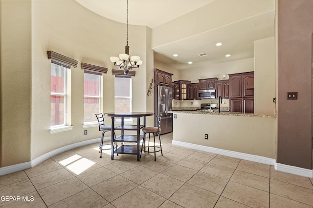 dining room featuring light tile patterned flooring, recessed lighting, baseboards, and an inviting chandelier