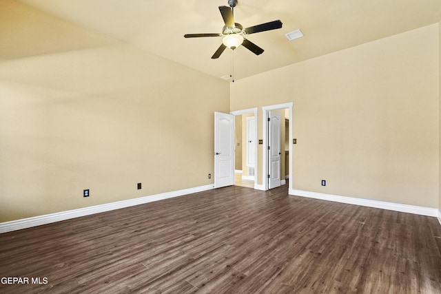 empty room featuring visible vents, baseboards, dark wood finished floors, and a ceiling fan