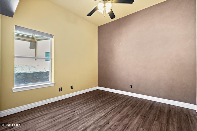 unfurnished room with dark wood-style floors, ceiling fan, and baseboards