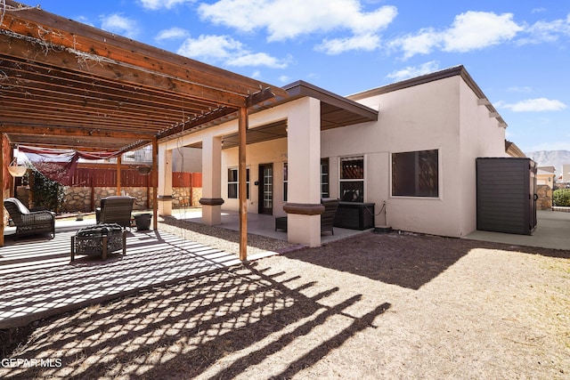 view of patio / terrace featuring a pergola, an outdoor fire pit, and fence