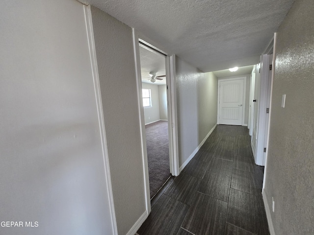 hallway featuring a textured ceiling