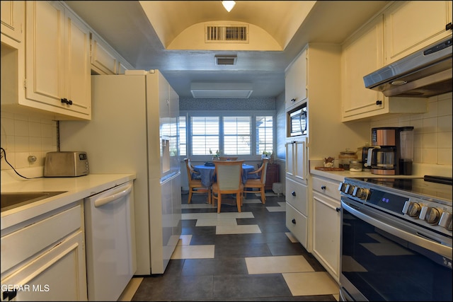 kitchen featuring appliances with stainless steel finishes, white cabinets, and decorative backsplash