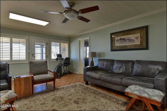 living room with ornamental molding and ceiling fan