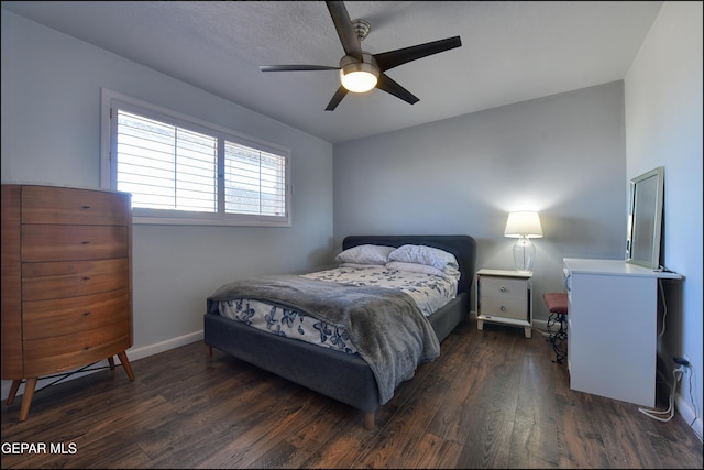 bedroom with dark hardwood / wood-style flooring and ceiling fan