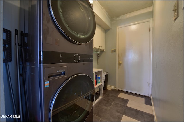 laundry room with stacked washing maching and dryer