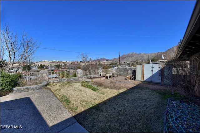 view of yard featuring a storage shed and a mountain view