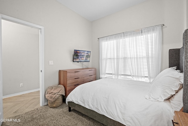 bedroom featuring parquet flooring