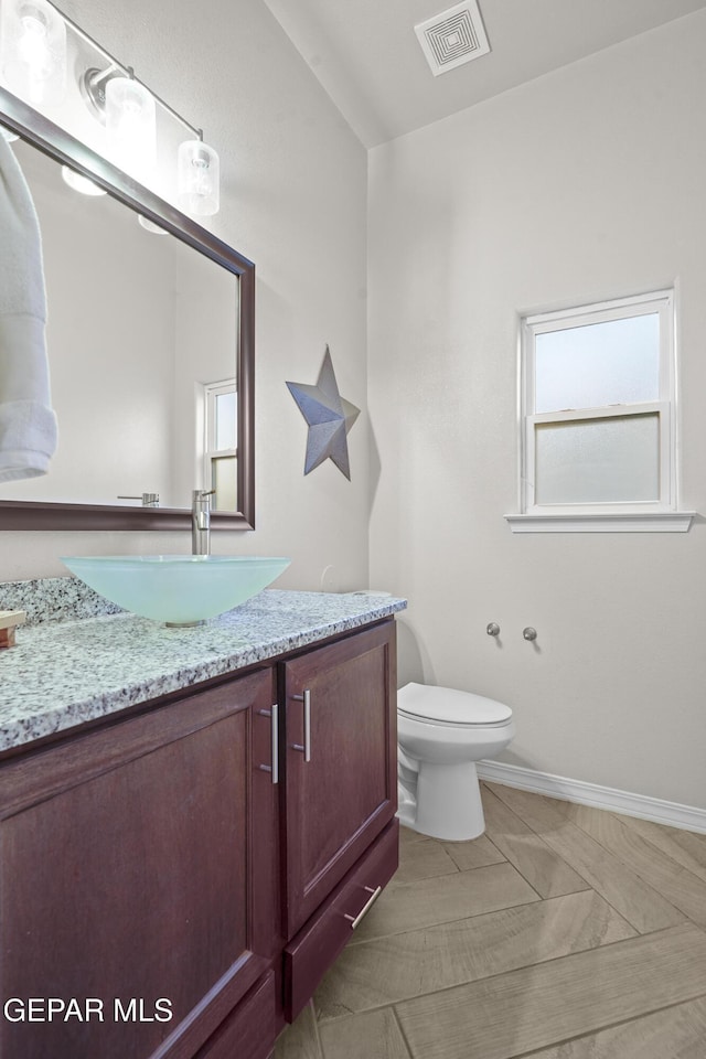 bathroom featuring vanity and toilet