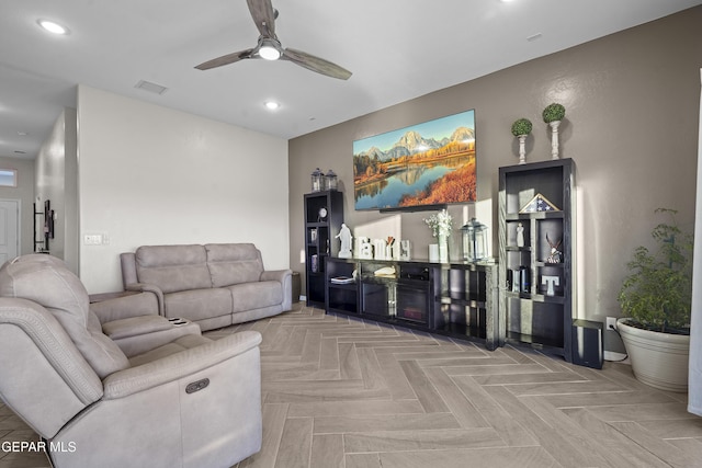 living room featuring light parquet floors and ceiling fan