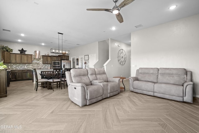 living room featuring light parquet floors and ceiling fan