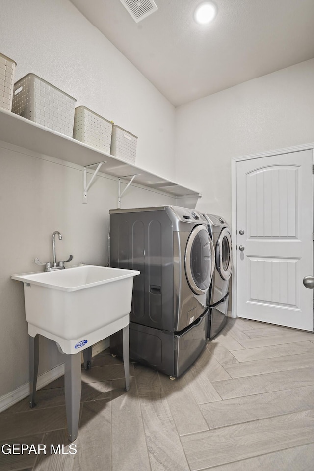 washroom with separate washer and dryer