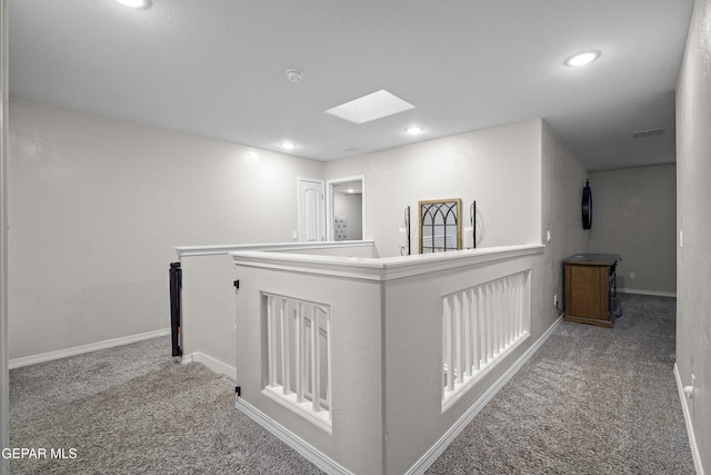 hall with carpet and a skylight