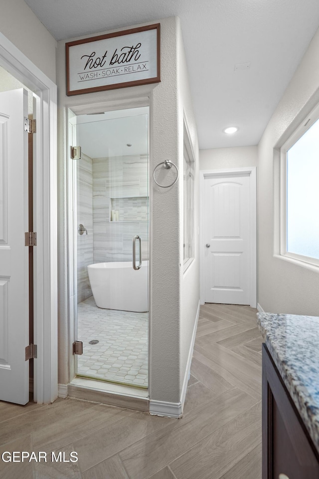 bathroom with vanity and independent shower and bath