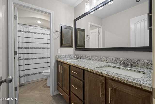 bathroom with a shower with curtain, vanity, and toilet