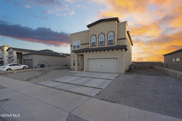 view of front of property with central AC and a garage