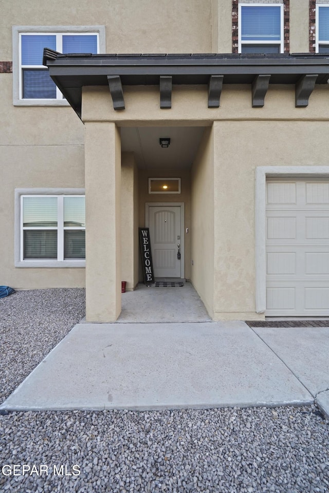 view of exterior entry featuring a garage